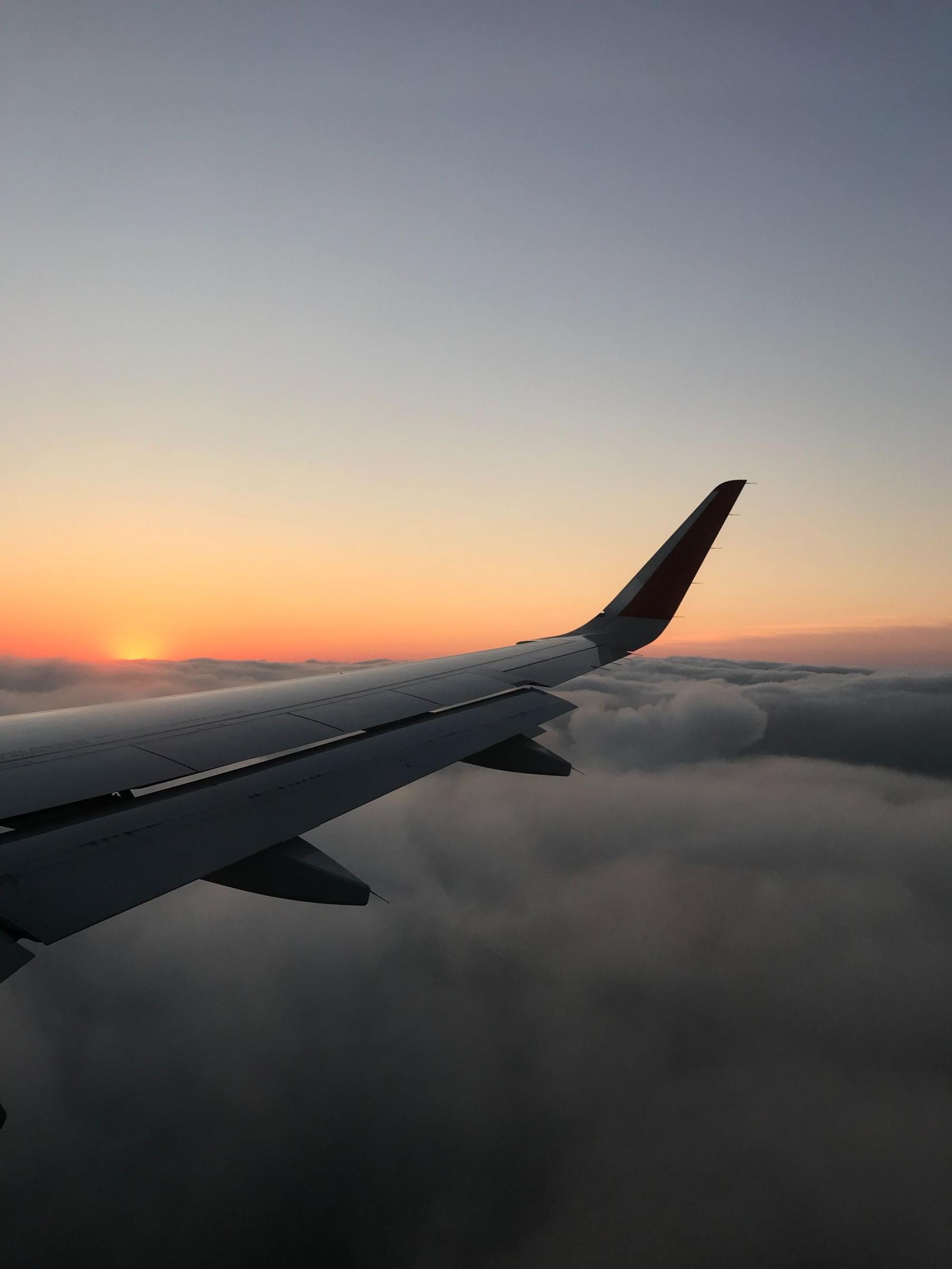 A wing above the cloud deck at dusk